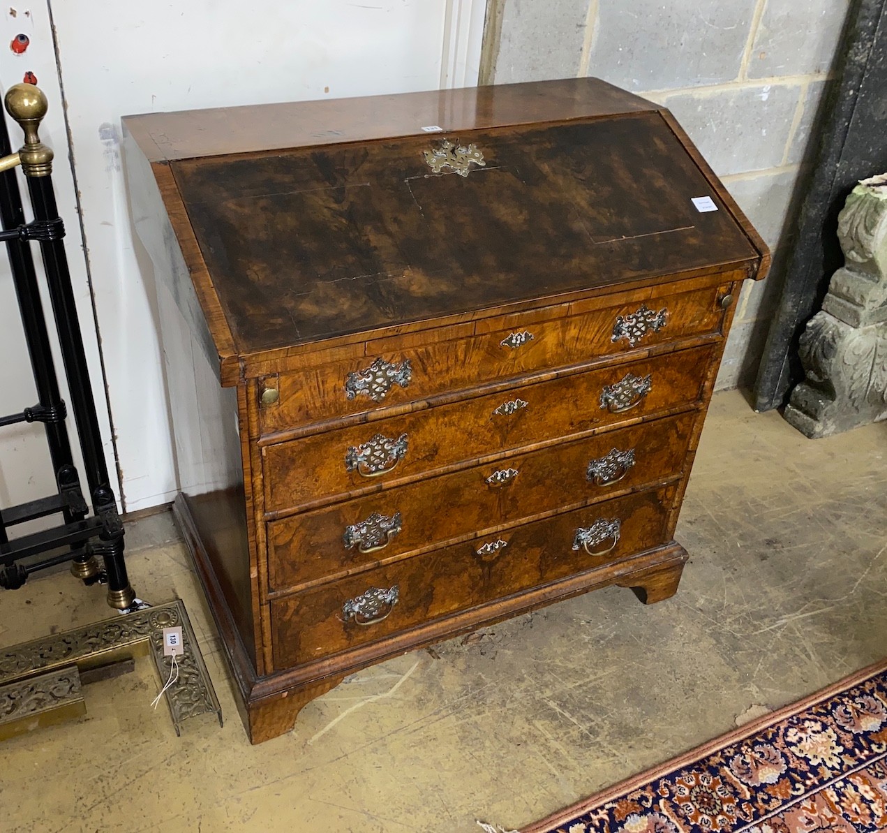 An 18th century walnut veneered bureau, adapted, fitted four graduating long drawers, width 97cm, depth 57cm, height 96cm